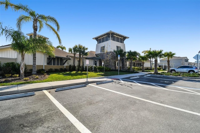 view of car parking featuring a lawn