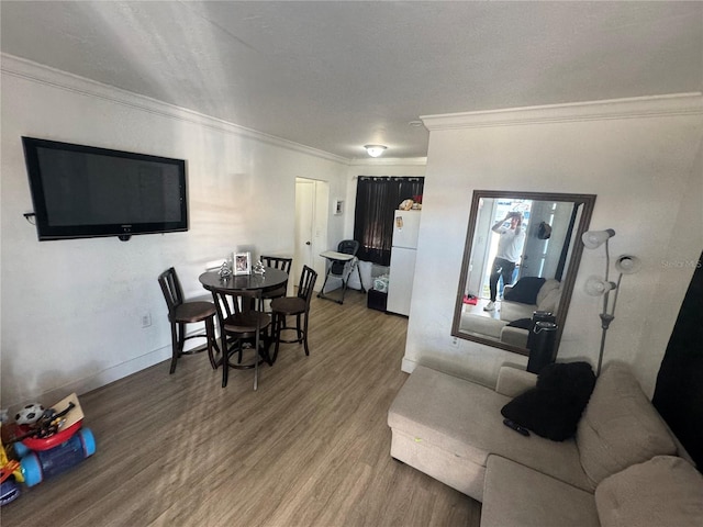 dining room featuring hardwood / wood-style flooring and crown molding