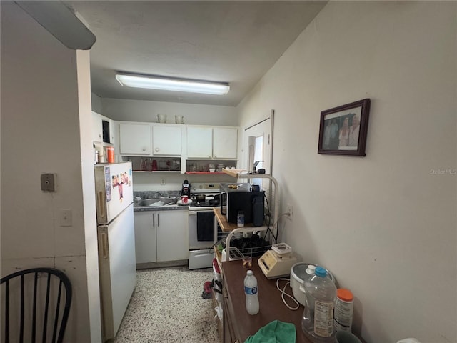 kitchen with white cabinetry and white appliances