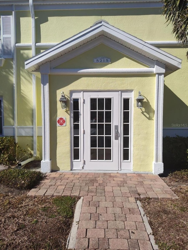 view of exterior entry featuring stucco siding