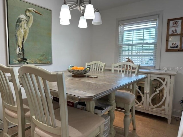 dining room with a notable chandelier and hardwood / wood-style flooring