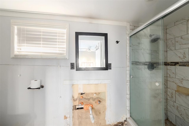 bathroom featuring a shower with door and ornamental molding