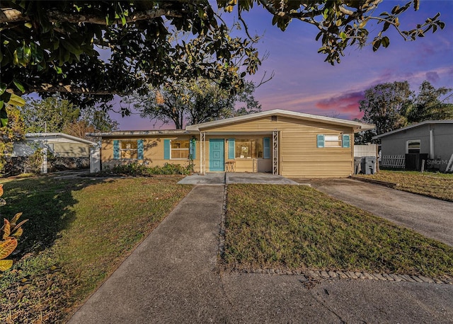 ranch-style home with a lawn