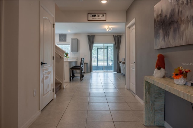 corridor featuring light tile patterned floors