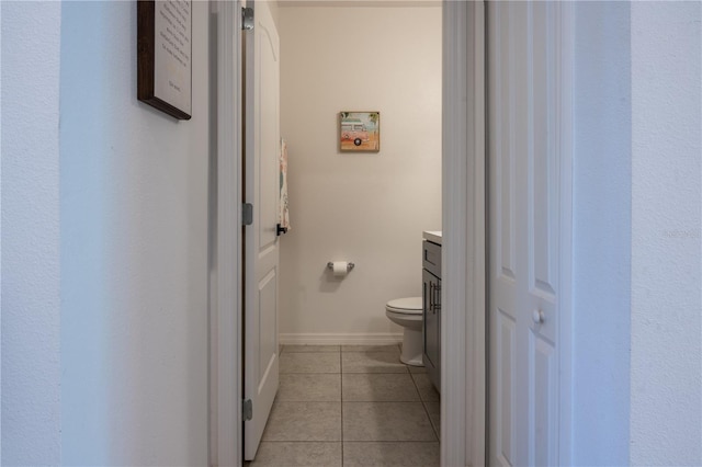 bathroom featuring tile patterned flooring, vanity, and toilet