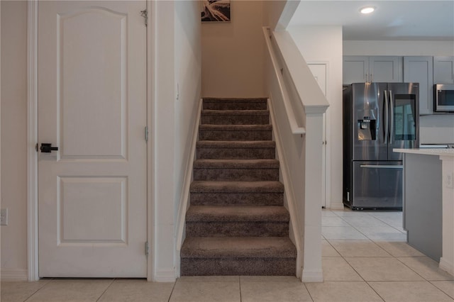 staircase with tile patterned floors