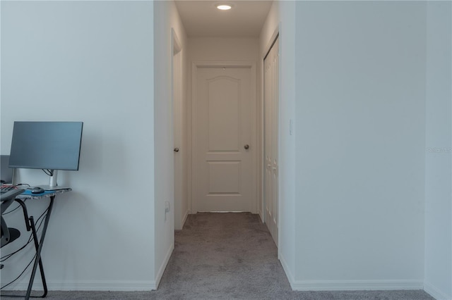 hallway with light colored carpet