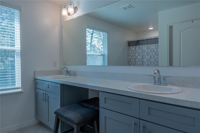 bathroom featuring tile patterned flooring, vanity, and a shower with shower curtain