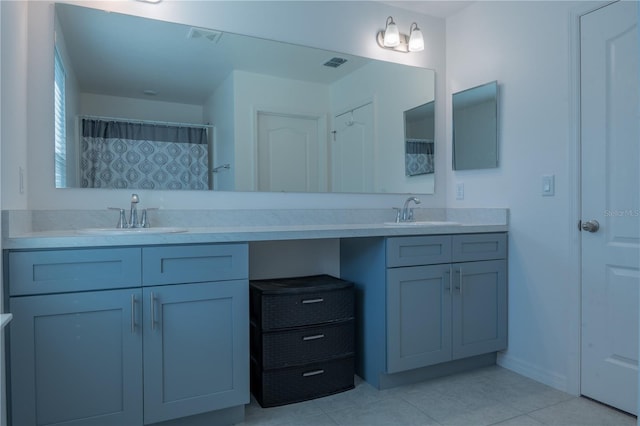 bathroom with tile patterned flooring and vanity