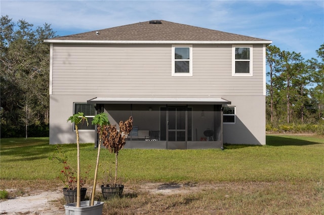 back of house with a sunroom and a yard