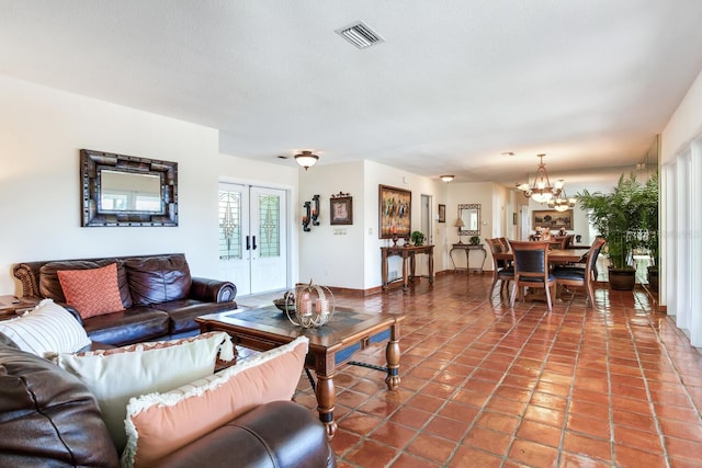 living room featuring tile patterned floors, french doors, and a textured ceiling