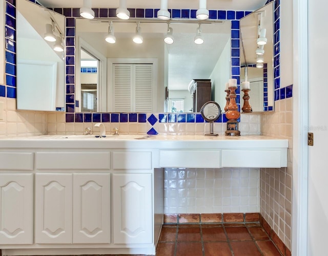 bathroom with vanity, backsplash, and tile patterned floors