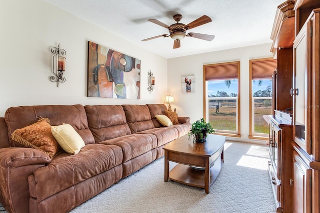 living room with ceiling fan and light colored carpet