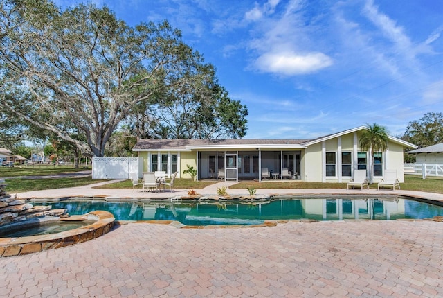 view of swimming pool featuring an in ground hot tub, a patio area, and a sunroom