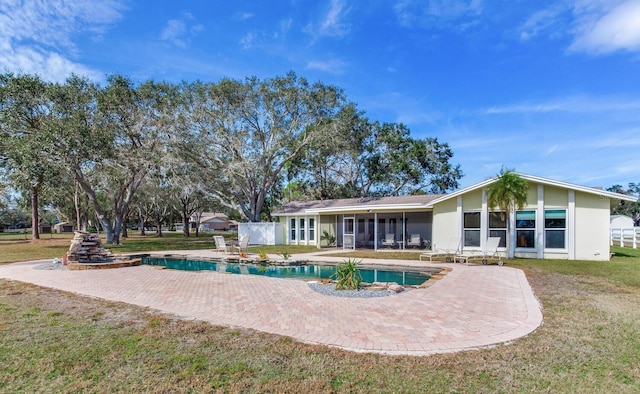 view of swimming pool featuring a yard and a patio area