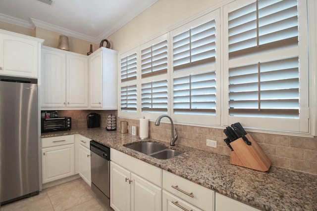 kitchen with white cabinetry, sink, ornamental molding, light stone counters, and stainless steel appliances