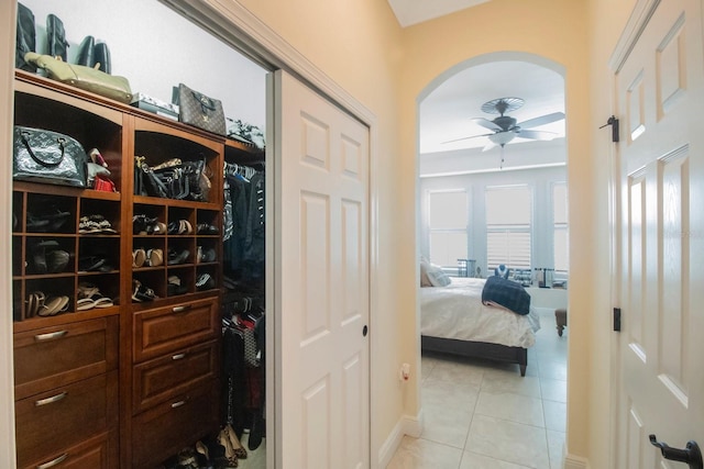 interior space with ceiling fan and light tile patterned floors