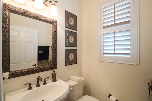 bathroom featuring toilet and sink