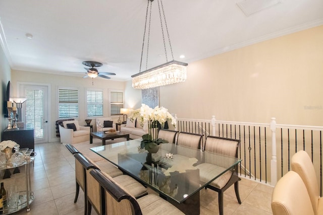 dining area with crown molding, ceiling fan, and light tile patterned flooring