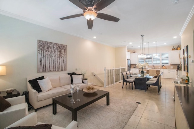 living room featuring light tile patterned floors, crown molding, and ceiling fan