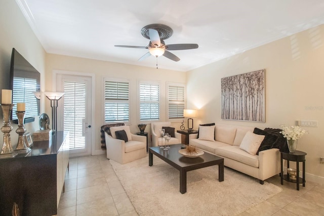 living room with ceiling fan, ornamental molding, and light tile patterned floors