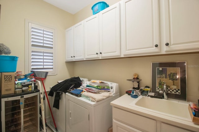 laundry area featuring cabinets, sink, and independent washer and dryer