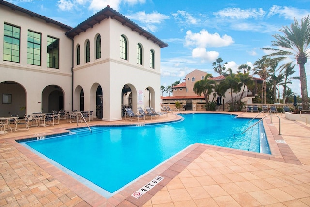 view of swimming pool featuring a patio area