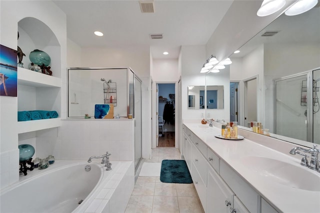 bathroom featuring tile patterned flooring, shower with separate bathtub, and vanity