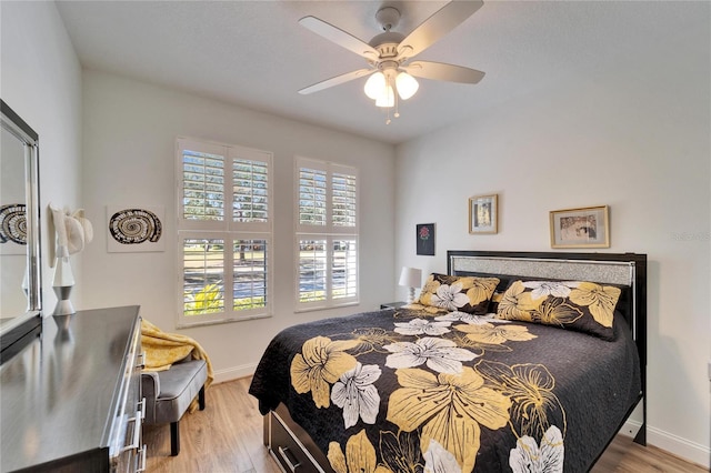 bedroom with ceiling fan and light wood-type flooring