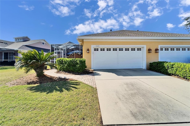 view of front facade with a garage, a lanai, and a front yard