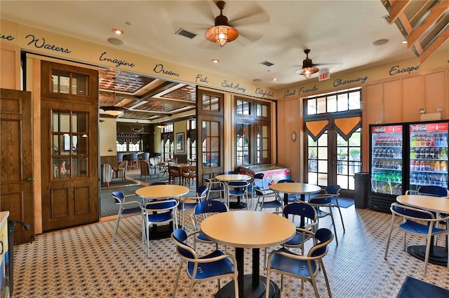 carpeted dining area featuring coffered ceiling, french doors, and ceiling fan