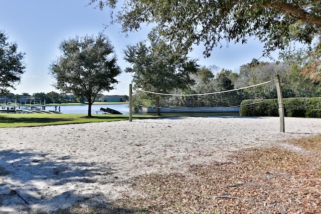 view of community with volleyball court and a water view