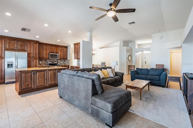 tiled living room featuring ceiling fan and sink