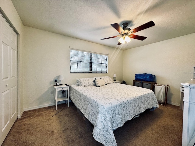 carpeted bedroom with a closet, ceiling fan, and a textured ceiling