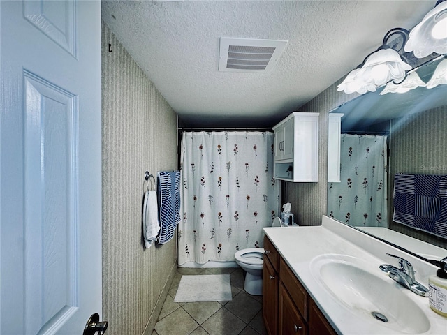 full bathroom featuring a textured ceiling, toilet, tile patterned floors, shower / bath combo, and vanity