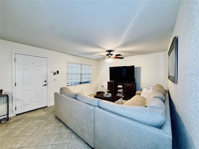 living room with light tile patterned flooring, a textured ceiling, and ceiling fan