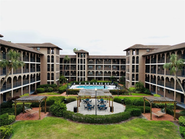 view of pool featuring a lawn