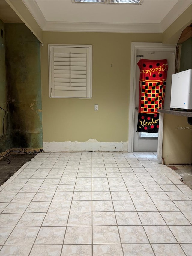 tiled spare room with ornamental molding