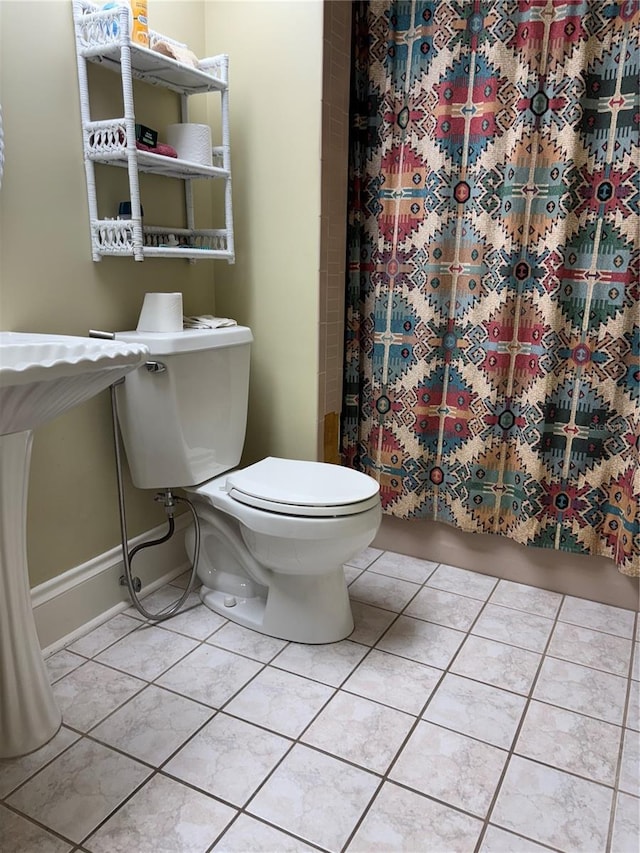 bathroom with tile patterned floors and toilet