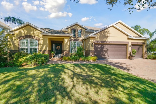 view of front of home with a front lawn and a garage