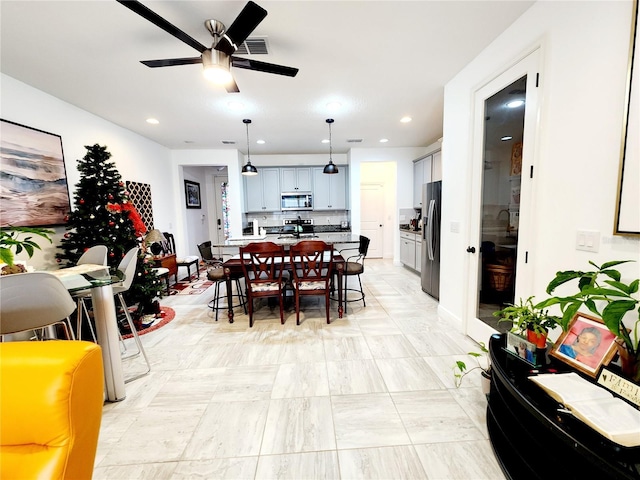 dining room featuring ceiling fan