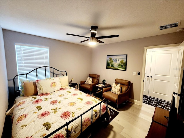 bedroom with ceiling fan and light hardwood / wood-style floors