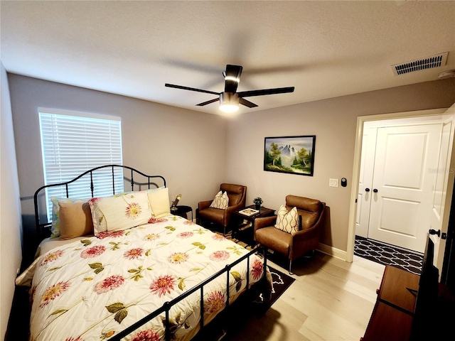 bedroom featuring light wood-type flooring and ceiling fan