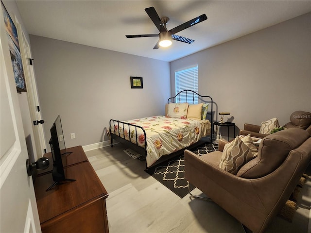 bedroom with ceiling fan and light hardwood / wood-style flooring