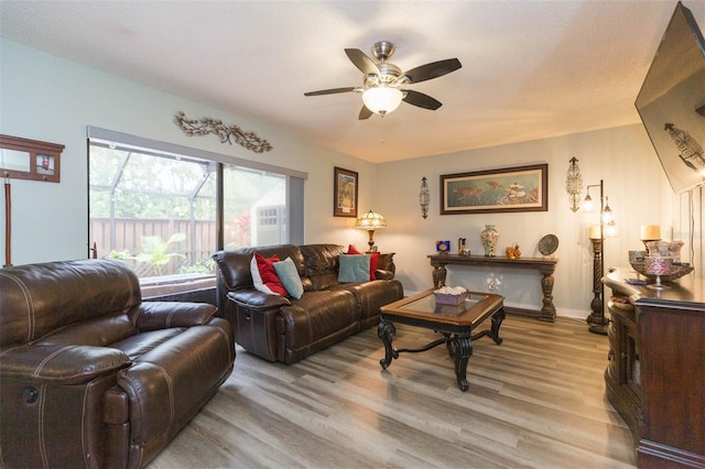 living room with ceiling fan and light wood-type flooring