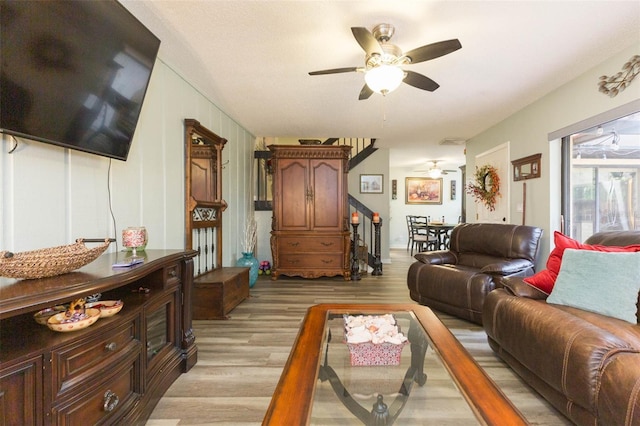 living room featuring ceiling fan and light hardwood / wood-style floors