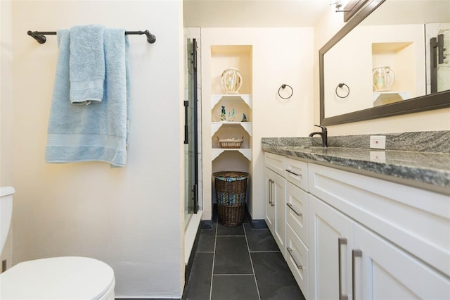 bathroom featuring tile patterned flooring, vanity, and toilet