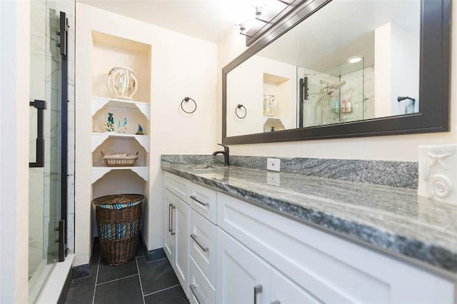 bathroom featuring tile patterned flooring, vanity, and an enclosed shower