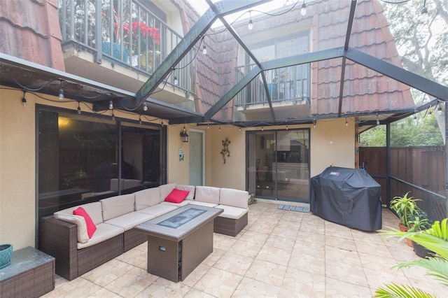 view of patio with a balcony, area for grilling, and an outdoor living space with a fire pit