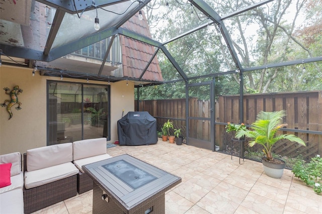 view of patio with outdoor lounge area, glass enclosure, and a grill